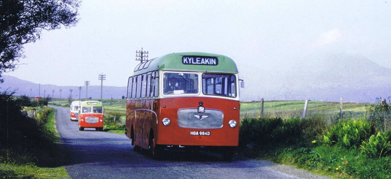 1966 - Convoy of MacBraynes buses travelling through Breakish with Beinn na Caillich ringed in mist