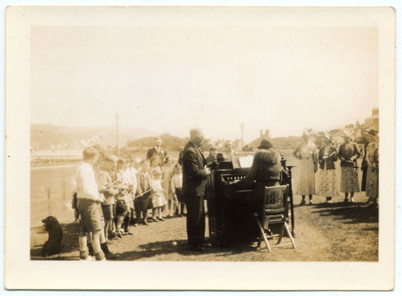 The boy on the left is Ian Robertson. The boy with the kilt (next to the little girl who is Ella Munro) is Douglas (Dougie) Munro, the missionary by the organ is their father Dugald Munro.