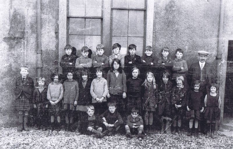 Kyleakin Public School 1930 - Headmaster Mr MacIver
Back row: Jocky Reid, Sandy Finlayson [Priffy], John Reid, Donald John MacRae, Murdo John Nicolson [Nixie], Calum Graham [Paddy], Christopher MacRae (Struan Cottage), Lachie John MacDonald [Terry or Largy]
Middle row: Norrie MacIver, Mairi MacIver, Joey Reid, Isa Reid, Helen MacKenzie [Eilidh Beag], Mary Ann Robertson, Catherine Finlayson [Tats], Ena Graham, Catriona Finlayson [Tana], Katie MacRae [Katach], Nina MacIver, Marion Robertson, Cathy Robertson
Front row:  Donald John Finlayson, Sandy Finlayson [Red Sandy], John MacRae [Johnny K or Dago].